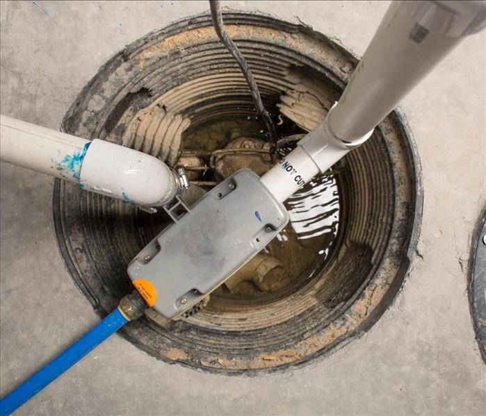 sump pump in cement basement floor