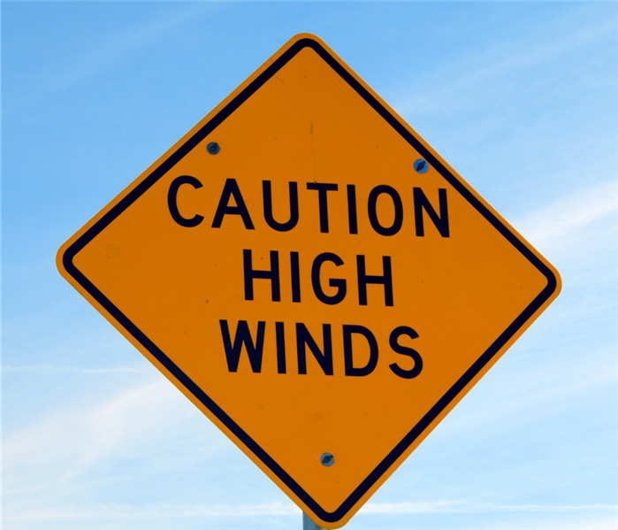 Picture shows a yellowish/orangeish sign that says Caution High Winds 