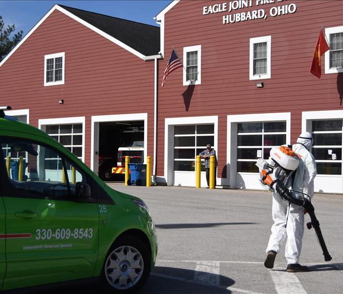 image of Fire Station and SERVPRO worker sanitizing the Fire truck parked